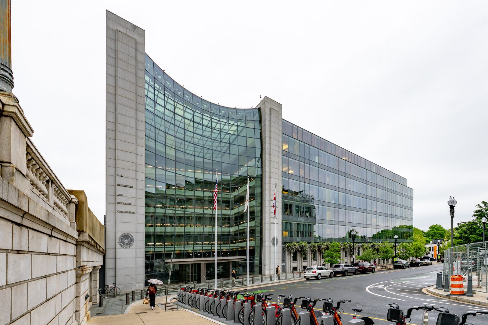 The glass-and-stone headquarters of the U.S. Securities and Exchange Commission at 100 F Street NE in Washington, D.C., photographed from across the street on a clear spring afternoon