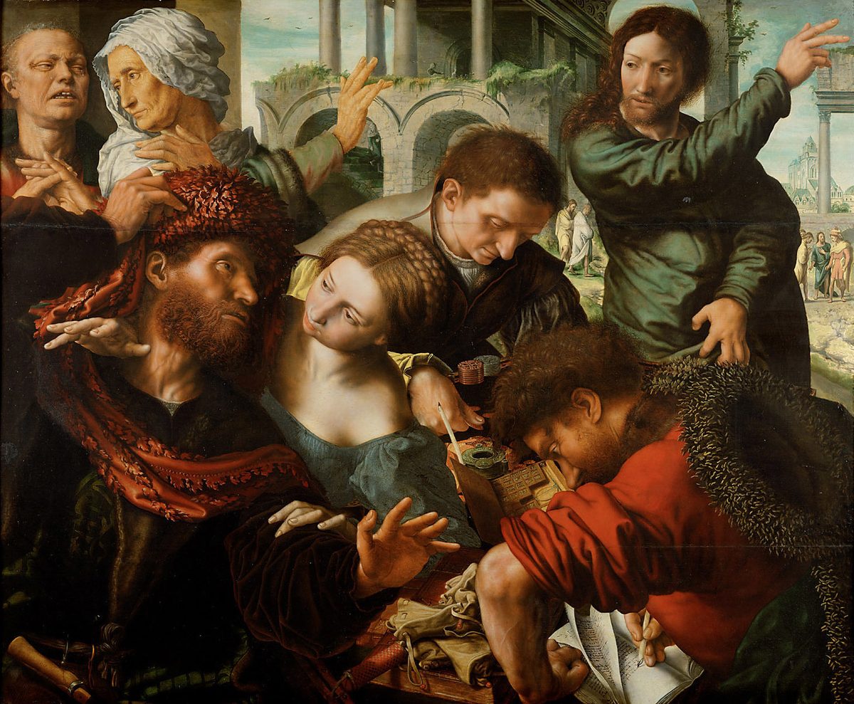A crowded half-length scene pressed close to the picture plane. At the right, Christ in green, haloed, one arm flung up and out of the frame, the other hand reaching down toward a table heaped with coins, a green money-box, purses and an open ledger. At the lower right a man in red with a fur collar bends over the ledger with a pen in his hand, head down, still writing. Around the table a bearded man in a red fur-trimmed robe gestures, a woman in blue-green leans in, and a clerk counts. Behind, ruined arches open onto a landscape with small distant figures.