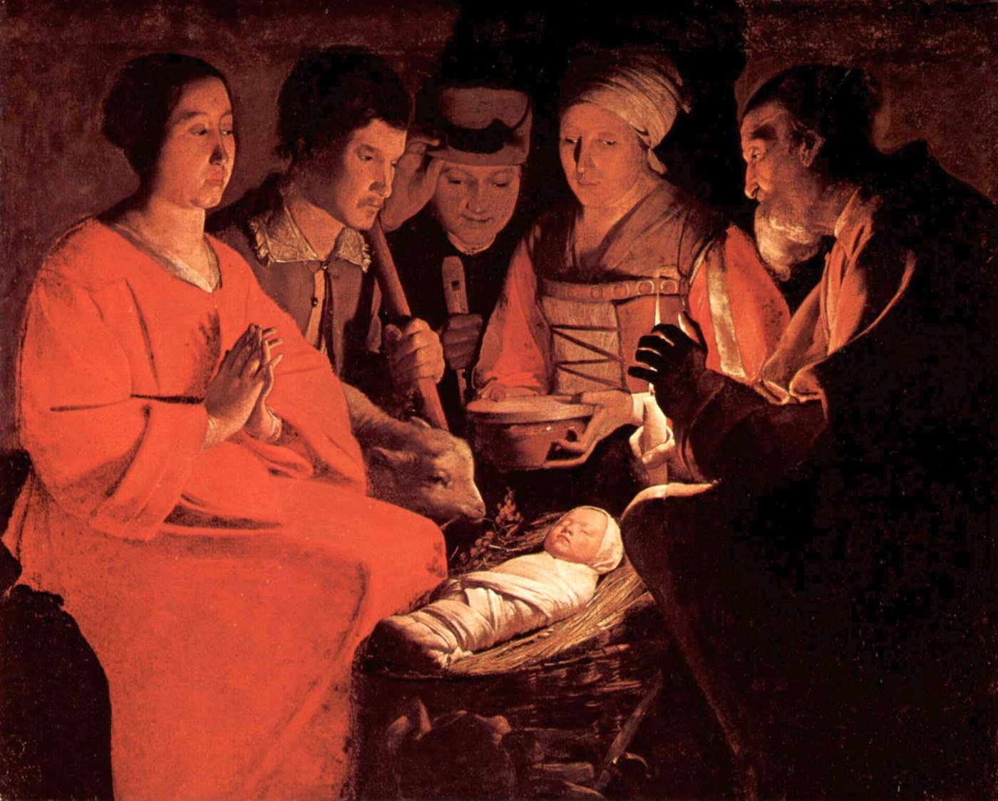 A dark painting lit by a single candle. Five adults stand shoulder to shoulder around a low crib of woven straw: a woman in red at the left with her hands joined, a young man behind her, a shepherd with a staff, a woman holding an earthenware bowl, and at the right an older man cupping his hand around the candle flame to shield it. In the crib a newborn lies wrapped tightly in white cloth with only his face showing, asleep. A lamb reaches down toward the straw beside his head. There is no architecture, no star, no angels, and nobody has a halo