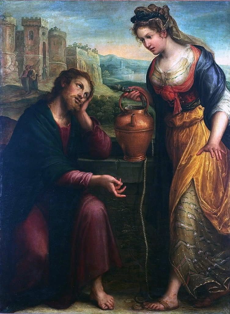 An oil painting. At the left, a bearded man in a dark blue mantle over a deep red robe sits on the stone kerb of a well, barefoot, resting his head on one hand as though tired, looking up; his other hand is open in front of him, mid-gesture. At the right a woman stands over him, taller in the frame, in a gold skirt, red bodice and blue mantle with a jewelled headdress, one hand on her hip and the other on a copper water jar that sits on the well kerb with a rope running down into the shaft. Behind them a landscape and a walled town, with three small figures on the road by its gate.