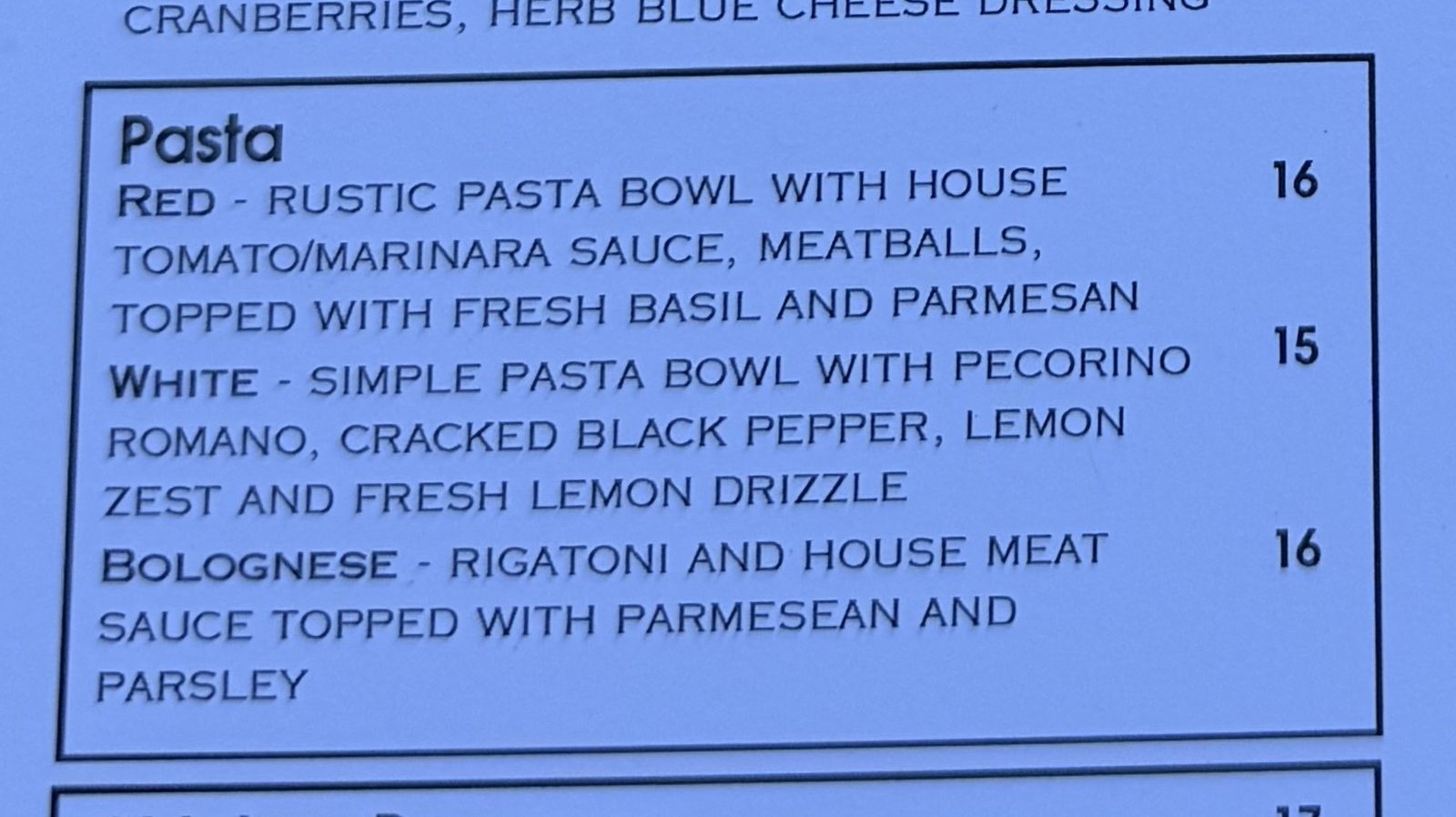 The Pasta section of the Chuckie Pies menu, printed on pale blue paper: Red, a rustic pasta bowl with house tomato and marinara sauce and meatballs topped with fresh basil and parmesan, sixteen dollars; White, a simple pasta bowl with pecorino romano, cracked black pepper, lemon zest and fresh lemon drizzle, fifteen dollars; and Bolognese, rigatoni and house meat sauce topped with parmesan and parsley, sixteen dollars