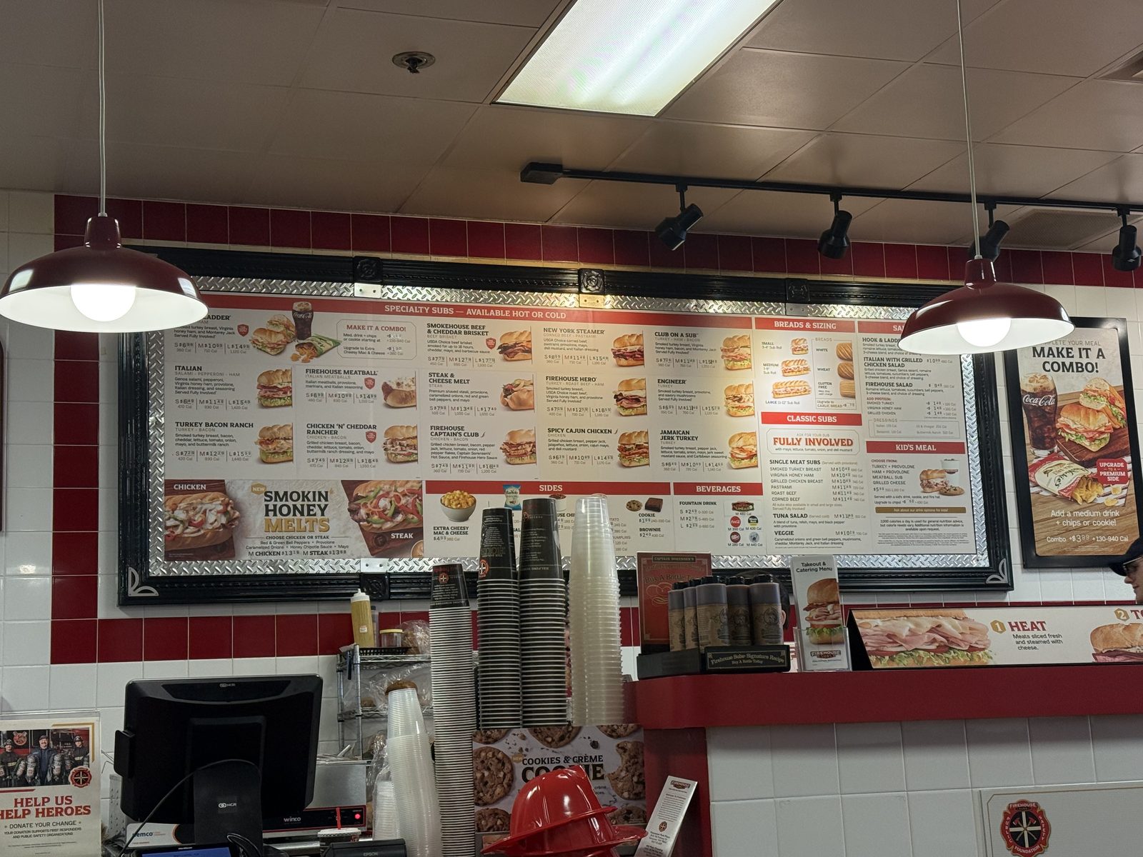 The full specialty subs menu board at Firehouse Subs, with a red boxed callout reading ASK FOR YOUR SUB FULLY INVOLVED beside the classic subs list