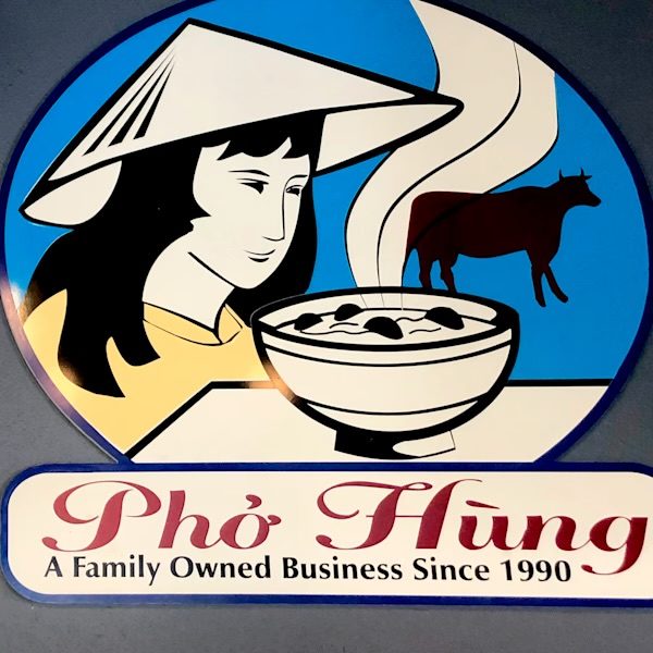 The Pho Hung logo — an illustration of a woman in a conical hat beside a steaming bowl of pho and a cow, above red script reading Pho Hung, A Family Owned Business Since 1990