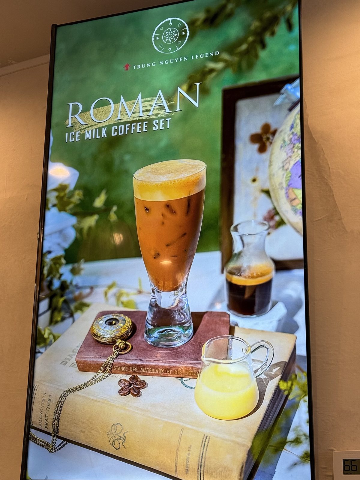 Digital menu board for the Roman Ice Milk Coffee Set, an iced coffee glass staged on an old book with a pocket watch