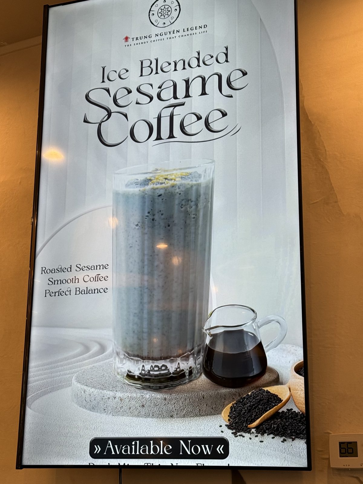 Digital menu board for Ice Blended Sesame Coffee, a gray blended drink next to black sesame seeds